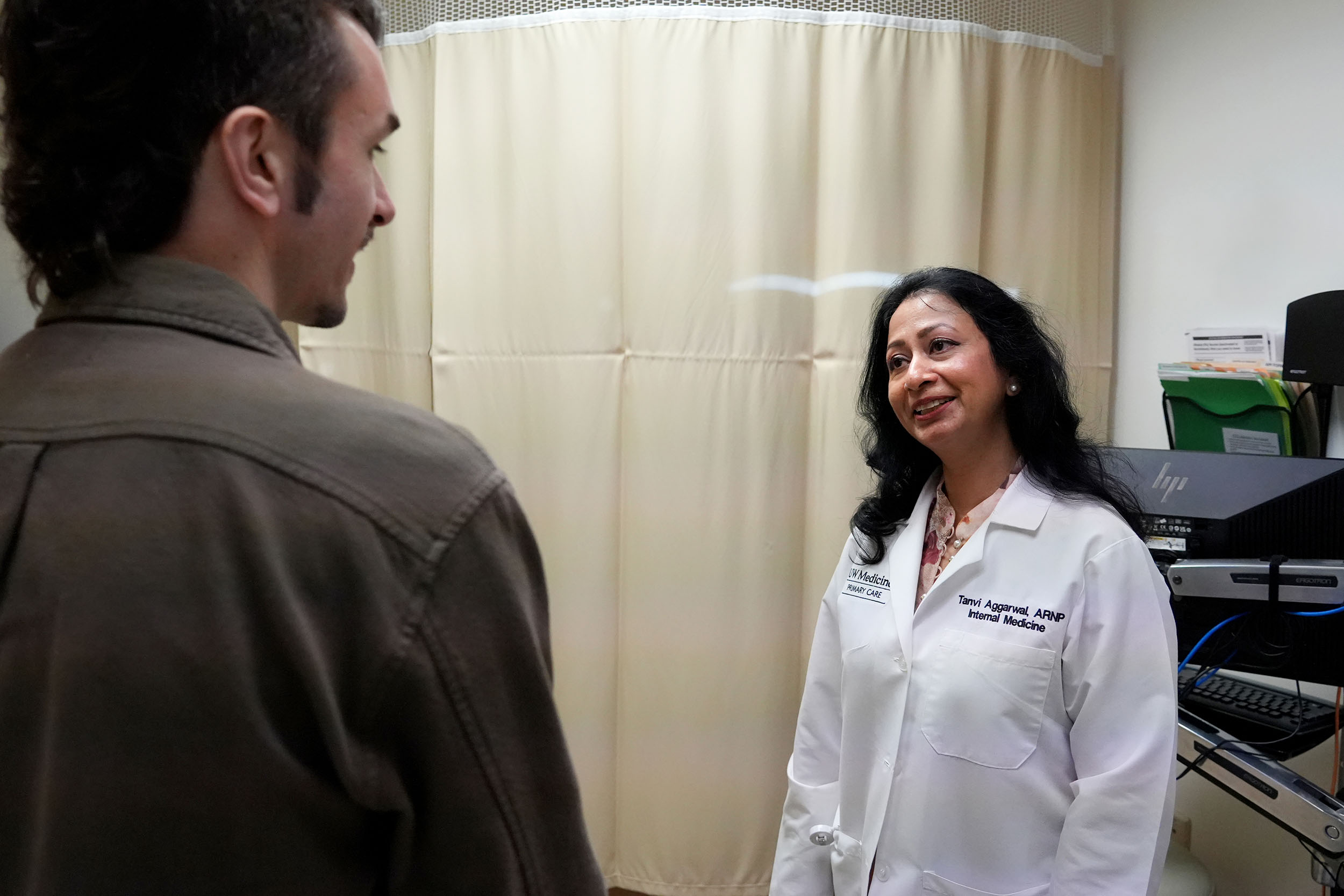 Nurse speaking with a student nurse in a clinical exam room